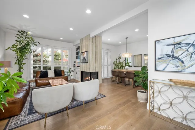 a living room with furniture potted plant and a large window