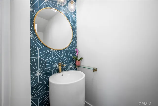 a bathroom with a sink mirror and toilet