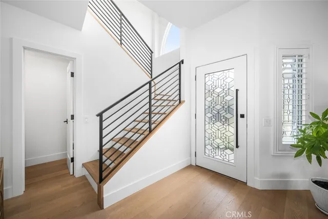 a view of entryway with wooden floor and stairs