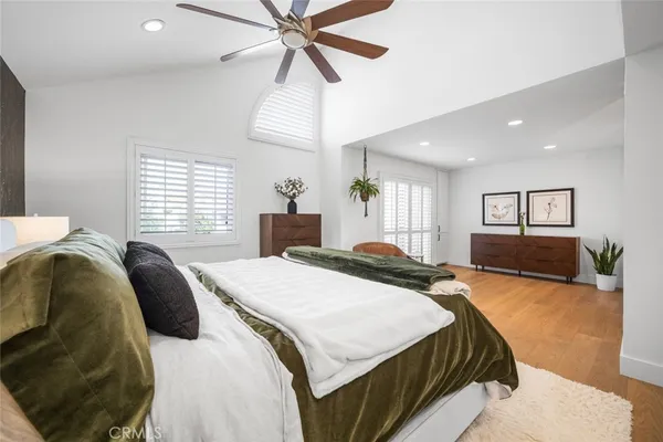 a spacious bedroom with a bed and a chandelier