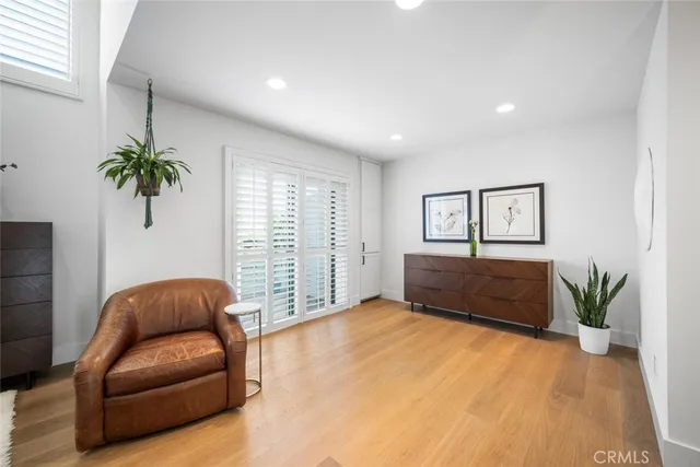 a living room with furniture plant and a window