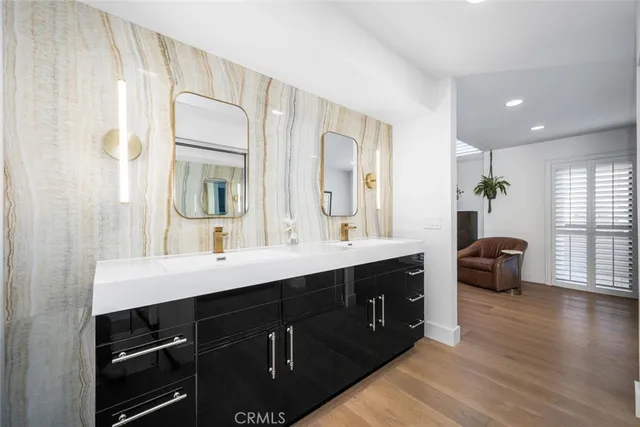 a view of a double vanity sink a mirror and a window