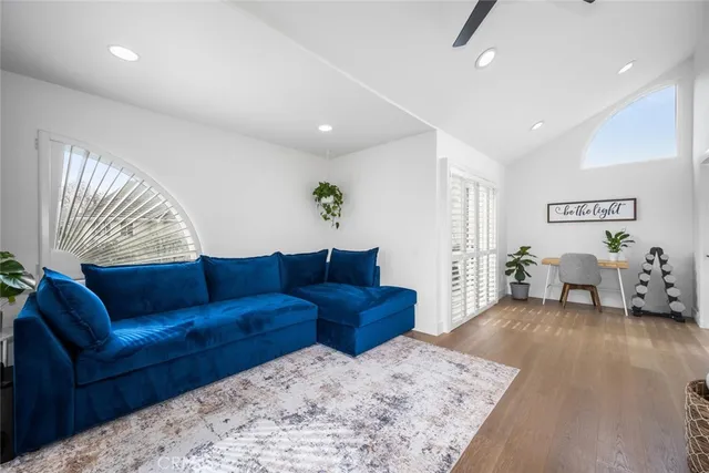 a living room with furniture and a potted plant
