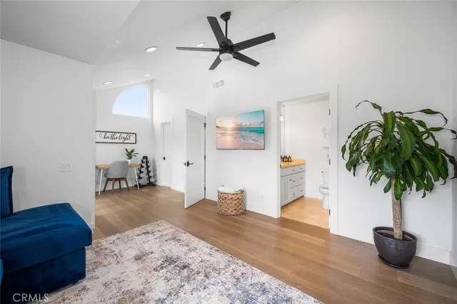a living room with furniture and a potted plant