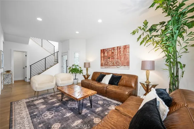 a living room with furniture and a potted plant