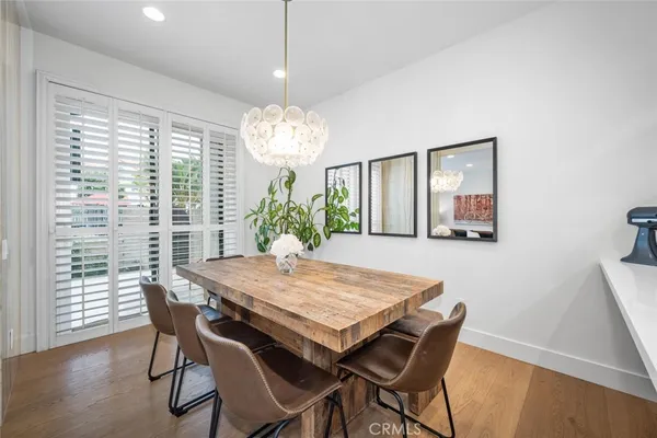 a view of a dining room with furniture wooden floor and chandelier