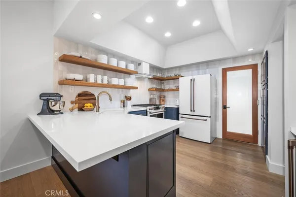 a kitchen with refrigerator and cabinets