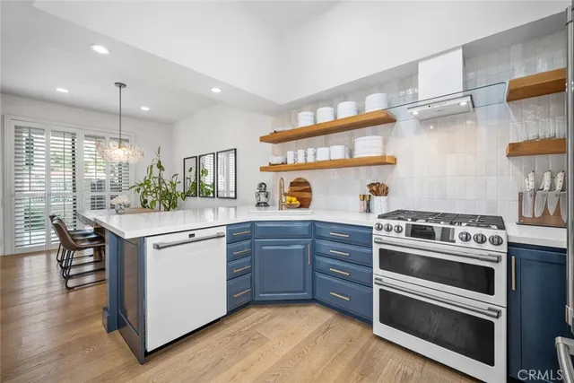 a kitchen with stainless steel appliances granite countertop a stove and a sink