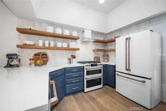 a kitchen with stainless steel appliances a refrigerator and stove