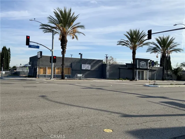 a view of road with palm trees