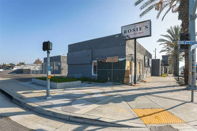 a street sign on a sidewalk next to a road
