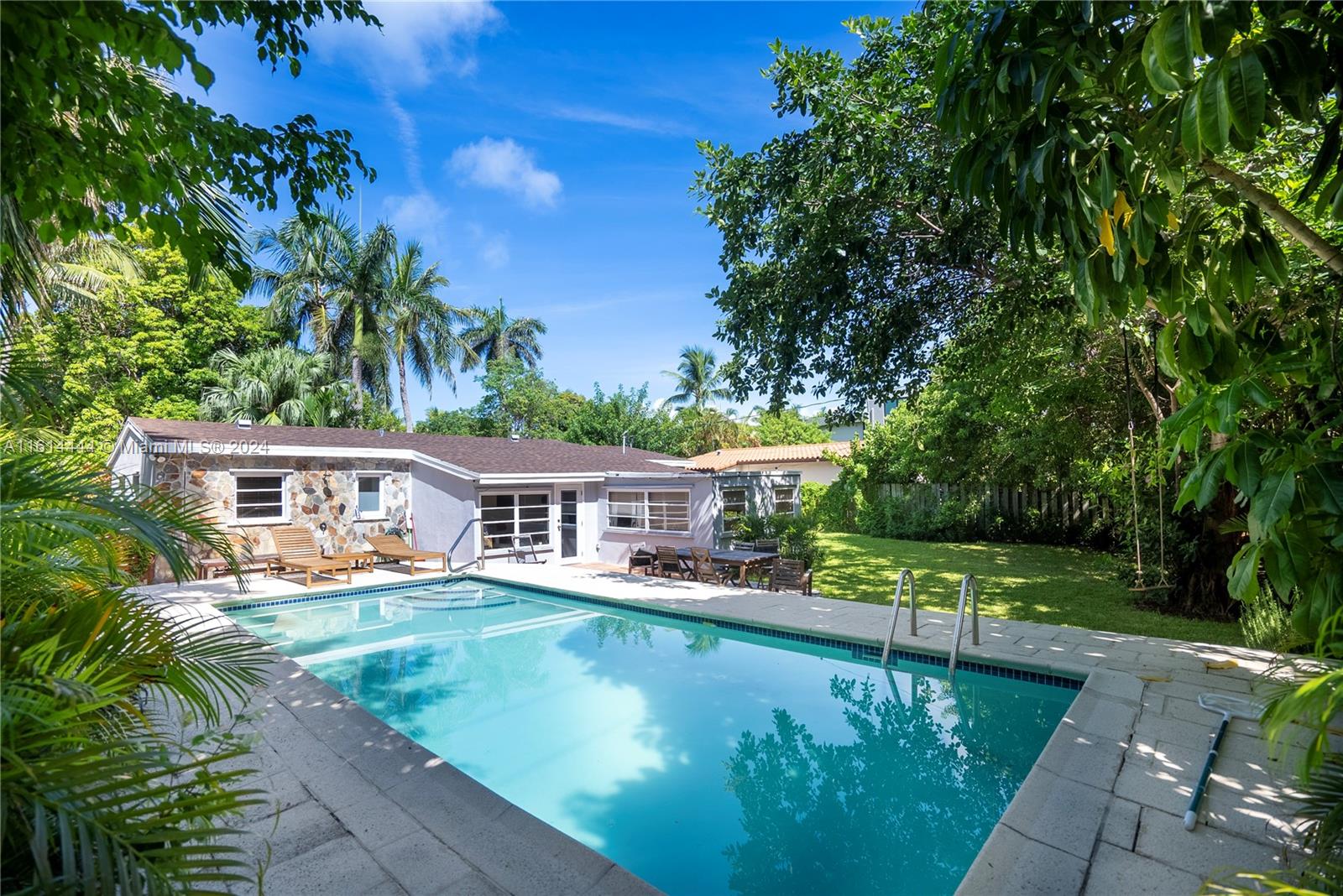 785 Fernwood Road Key Biscayne, FL 33149 - Photo 1 of 44 a view of a house with swimming pool and sitting area