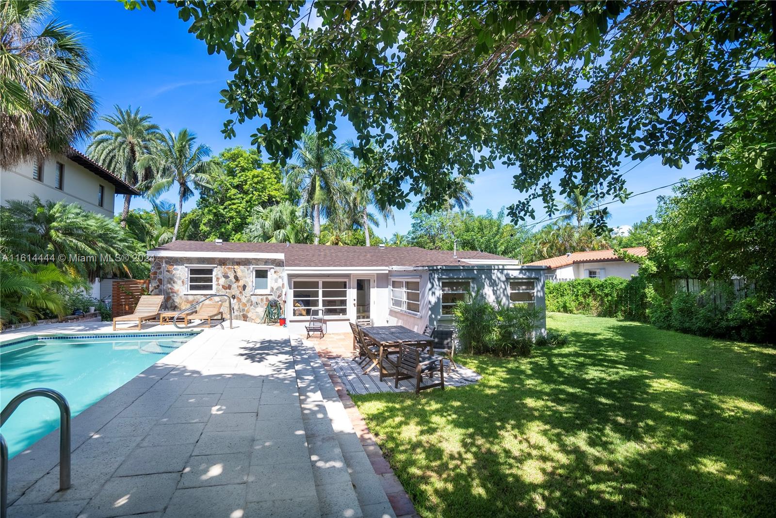 785 Fernwood Road Key Biscayne, FL 33149 - Photo 14 of 44 a front view of house with yard and green space