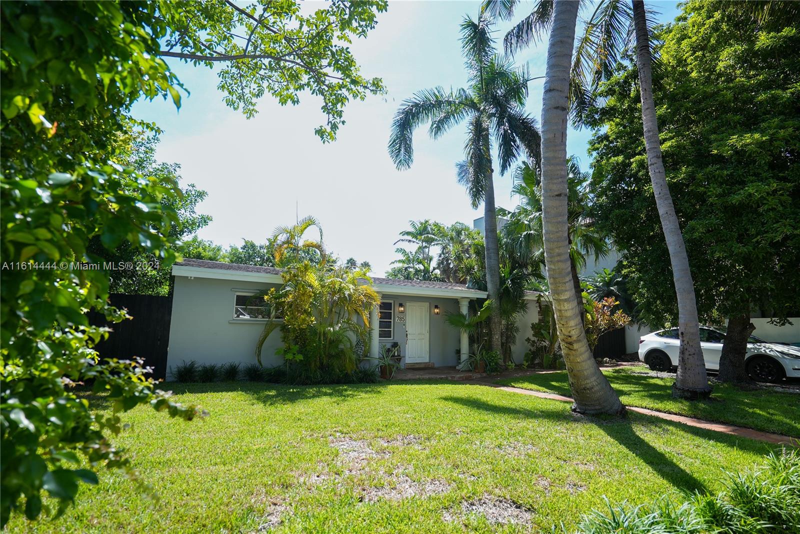 785 Fernwood Road Key Biscayne, FL 33149 - Photo 17 of 44 a view of a house with backyard and a tree
