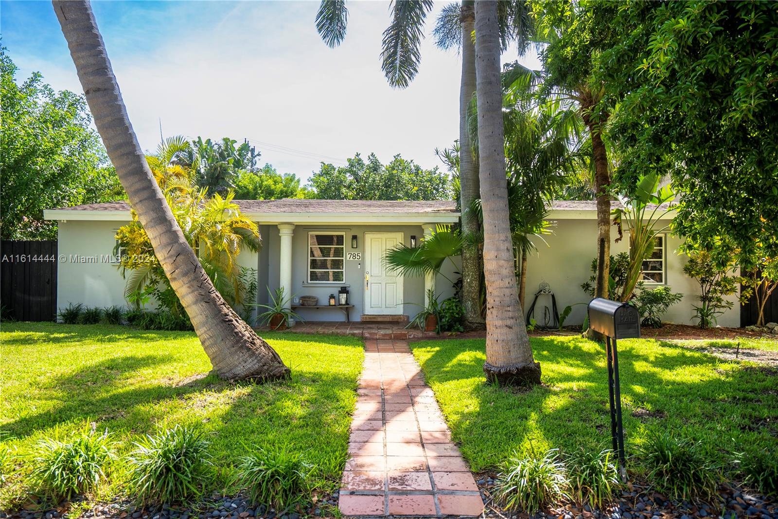 785 Fernwood Road Key Biscayne, FL 33149 - Photo 2 of 44 a view of a house with a swimming pool