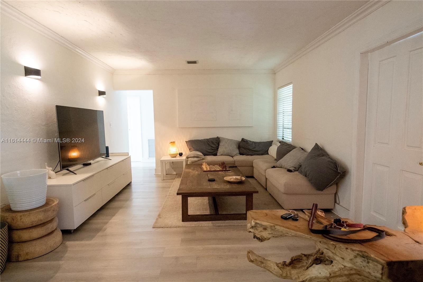 785 Fernwood Road Key Biscayne, FL 33149 - Photo 3 of 44 a living room with furniture and a flat screen tv