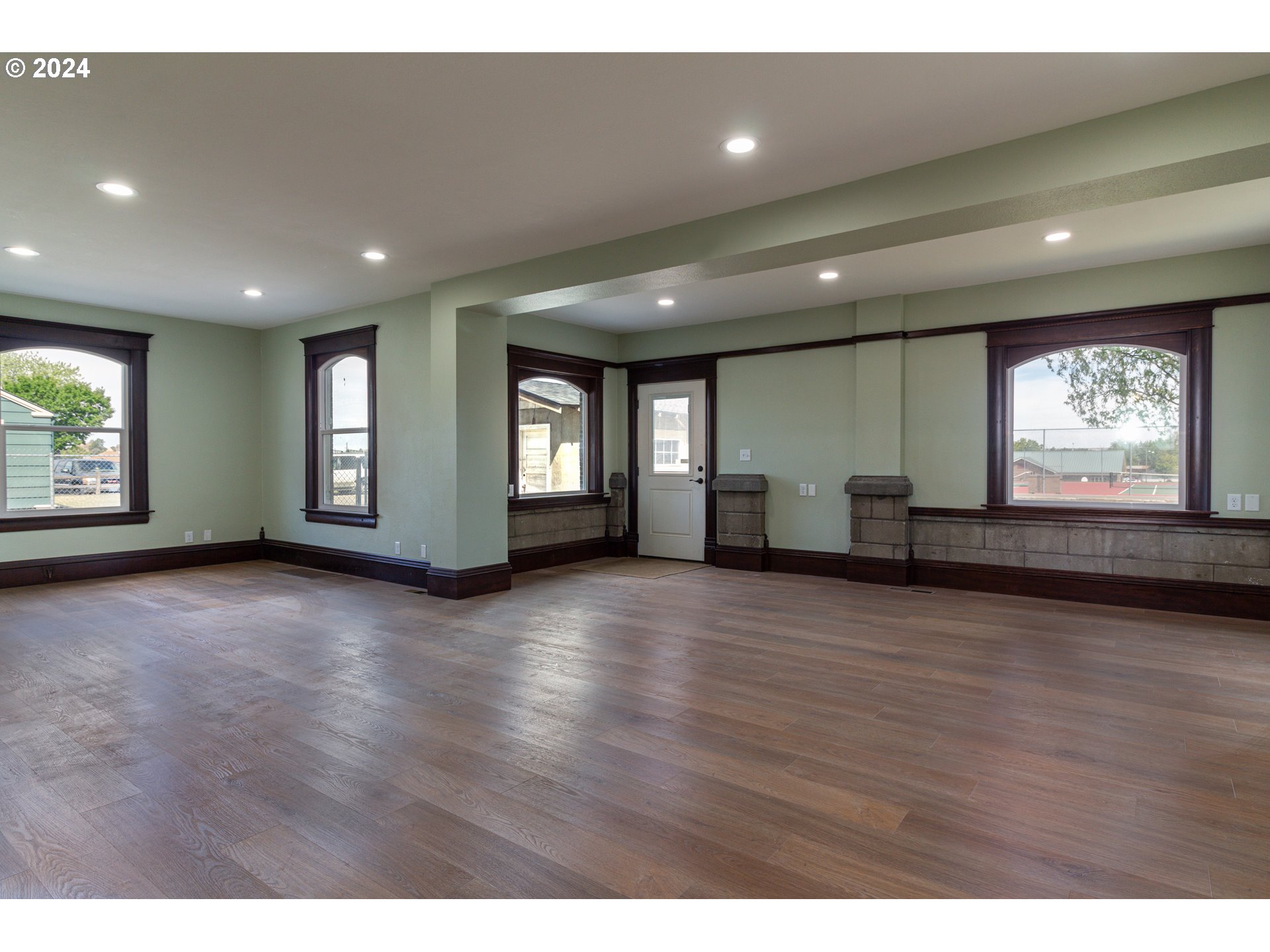235 Northeast 3rd Street Hermiston, OR 97838 - Photo 3 of 27 a view of an empty room with wooden floor and a window