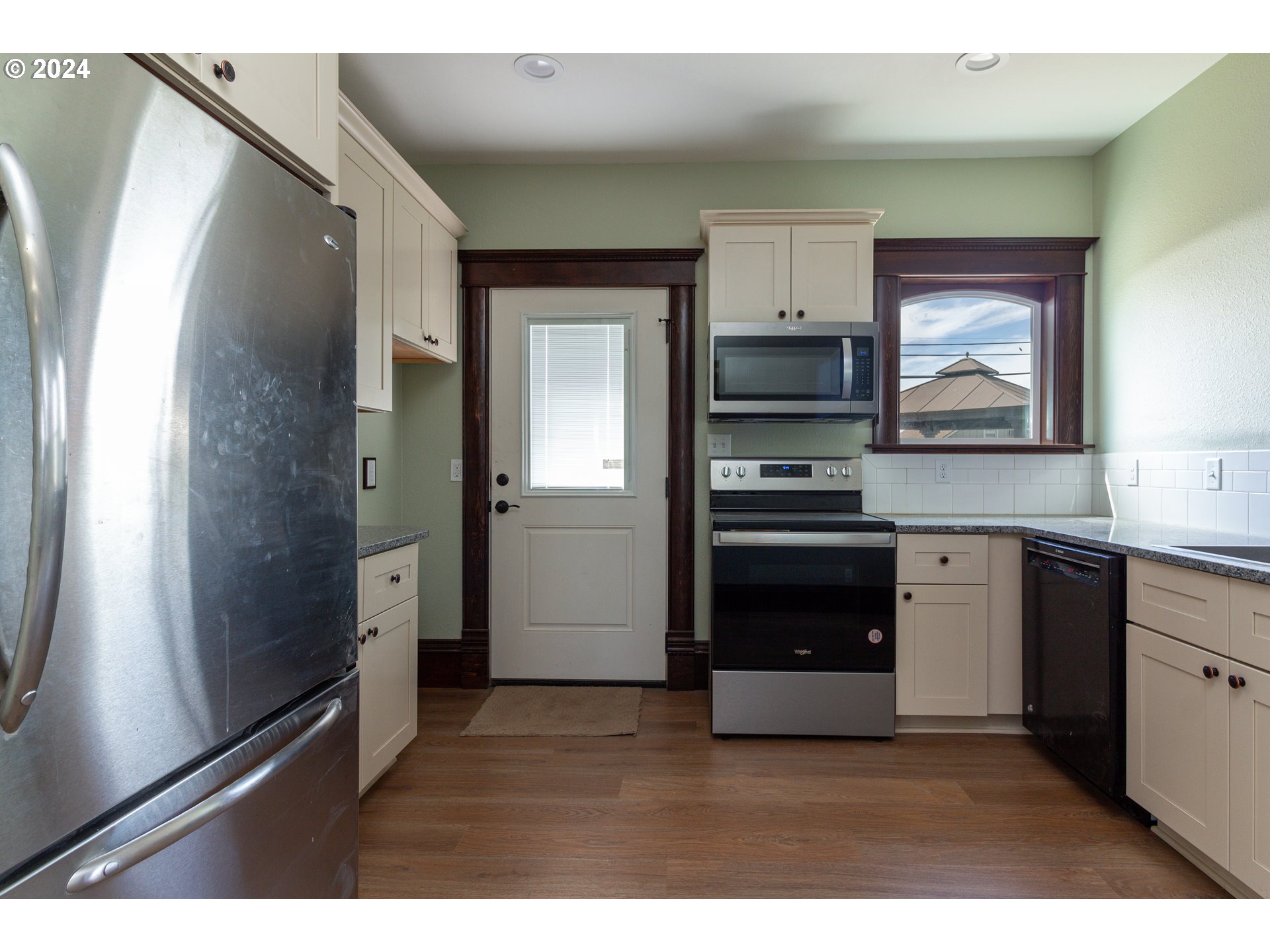 235 Northeast 3rd Street Hermiston, OR 97838 - Photo 10 of 27 a kitchen with a refrigerator and a stove