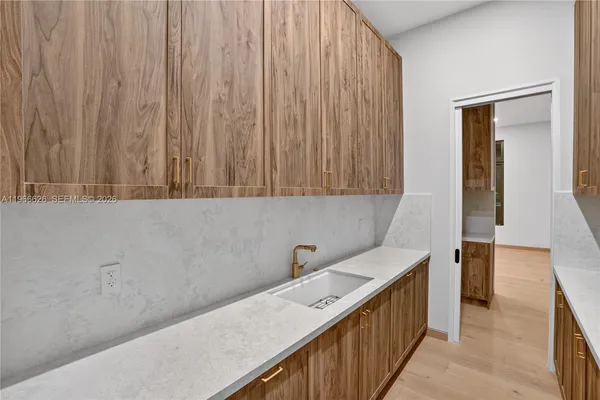 a hallway with a sink and cabinets