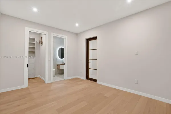 a bedroom with a bed and wooden floor