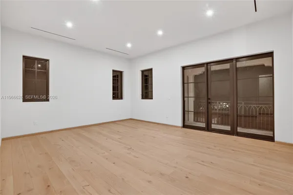 a view of an empty room with glass door