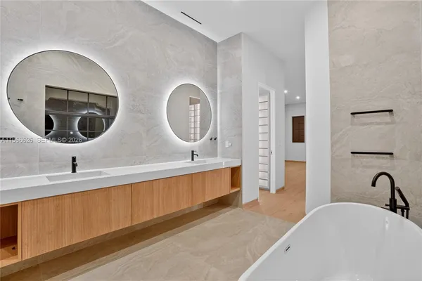 a bathroom with a double vanity sink and a mirror