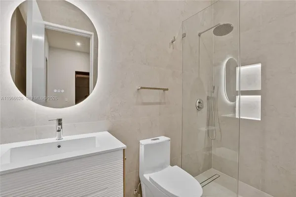 a bathroom with a toilet a sink and shower