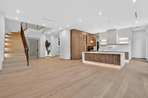 a view of kitchen with refrigerator microwave and wooden floor