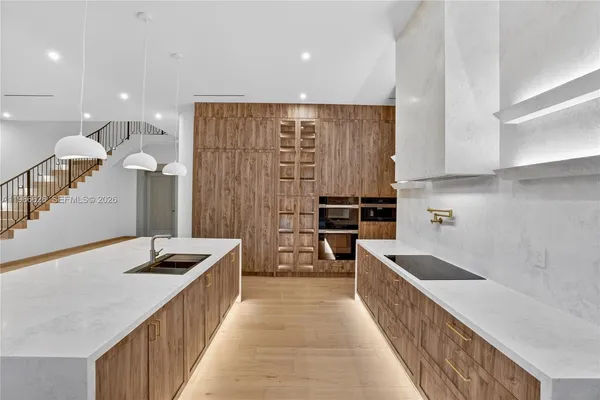 a kitchen with kitchen island granite countertop a sink and counter top space