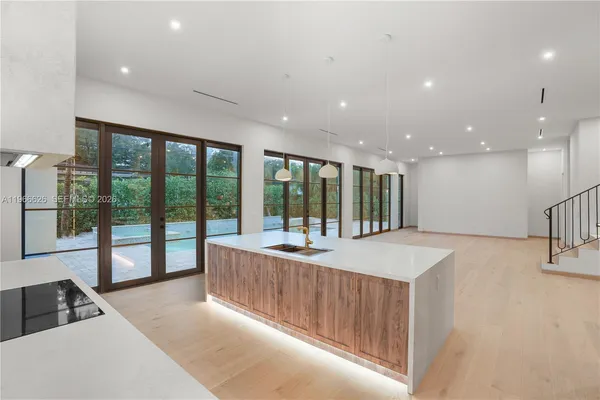 a large kitchen with kitchen island a large window