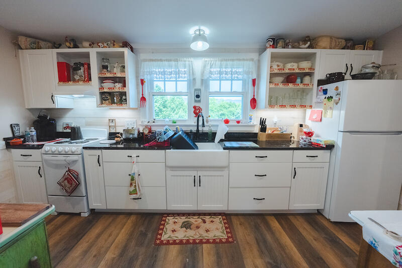 2598 Lone Ivy Road Stuart, VA 24171 - Photo 11 of 26 a kitchen with white cabinets and white appliances