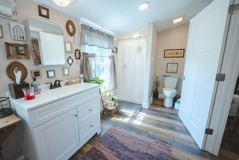 2598 Lone Ivy Road Stuart, VA 24171 - Photo 21 of 26 a bathroom with a sink mirror vanity and toilet