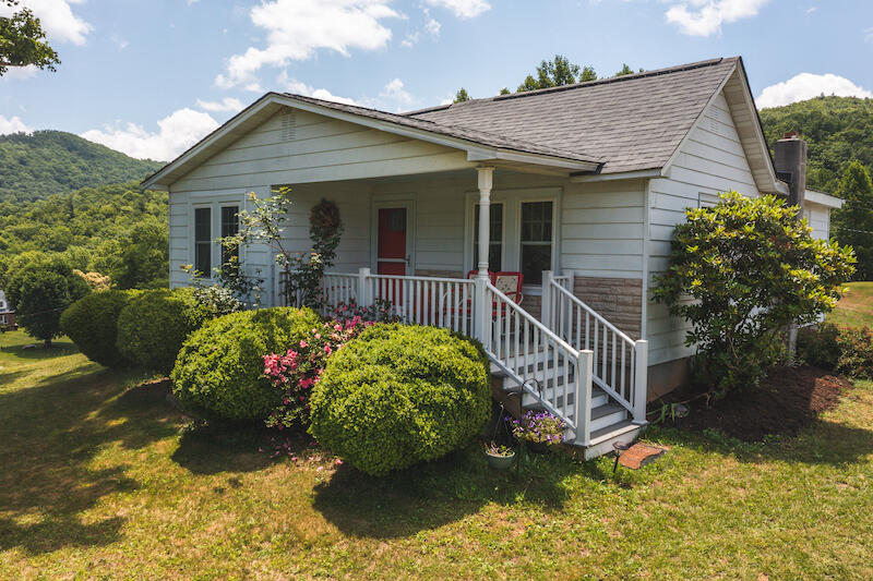 2598 Lone Ivy Road Stuart, VA 24171 - Photo 3 of 26 a front view of a house with a garden