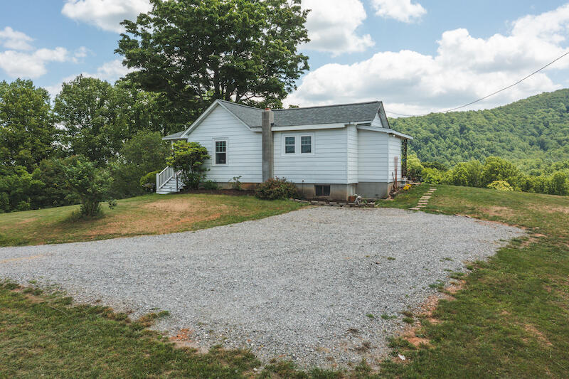 2598 Lone Ivy Road Stuart, VA 24171 - Photo 6 of 26 a view of a house with a yard and large trees