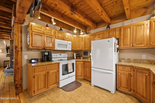 a kitchen with appliances a sink and cabinets