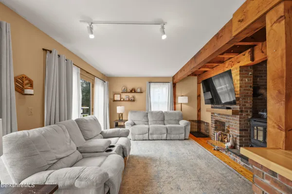 a living room with furniture fireplace and flat screen tv