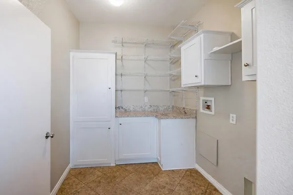 a bathroom with a granite countertop sink and a white cabinet