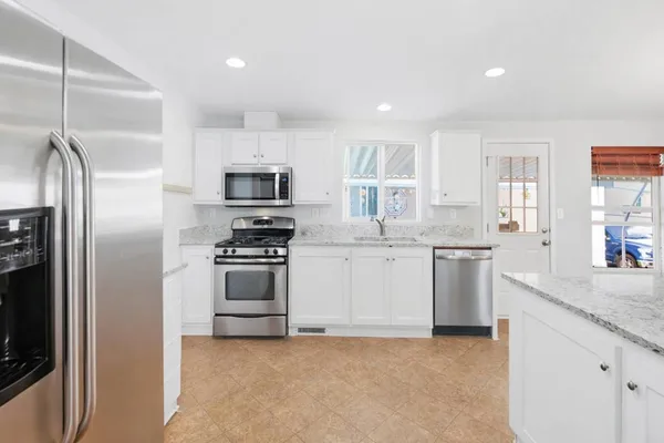 a kitchen with a sink stove and refrigerator