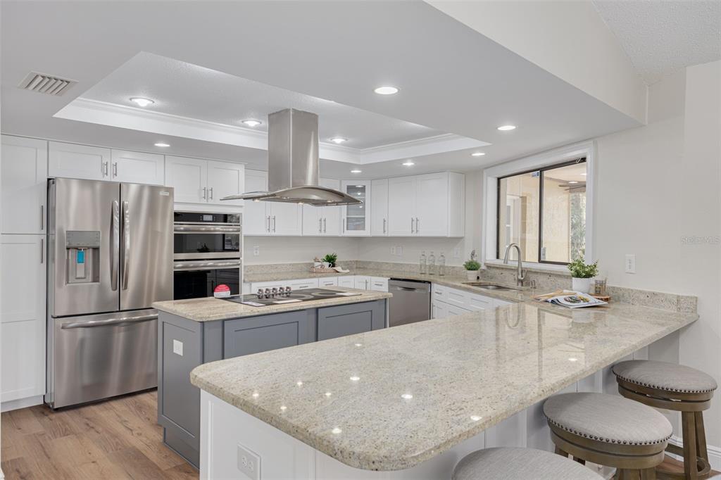 4415 Marine Parkway New Port Richey, FL 34652 - Photo 11 of 61 a kitchen with stainless steel appliances granite countertop a sink stove and refrigerator