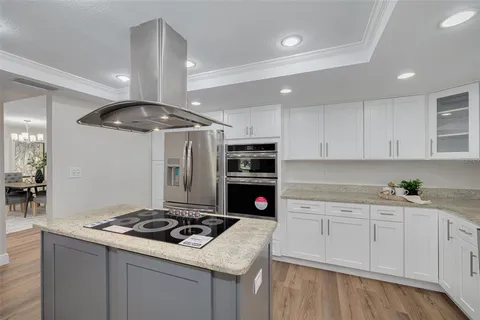 a kitchen with granite countertop a sink stove and cabinets