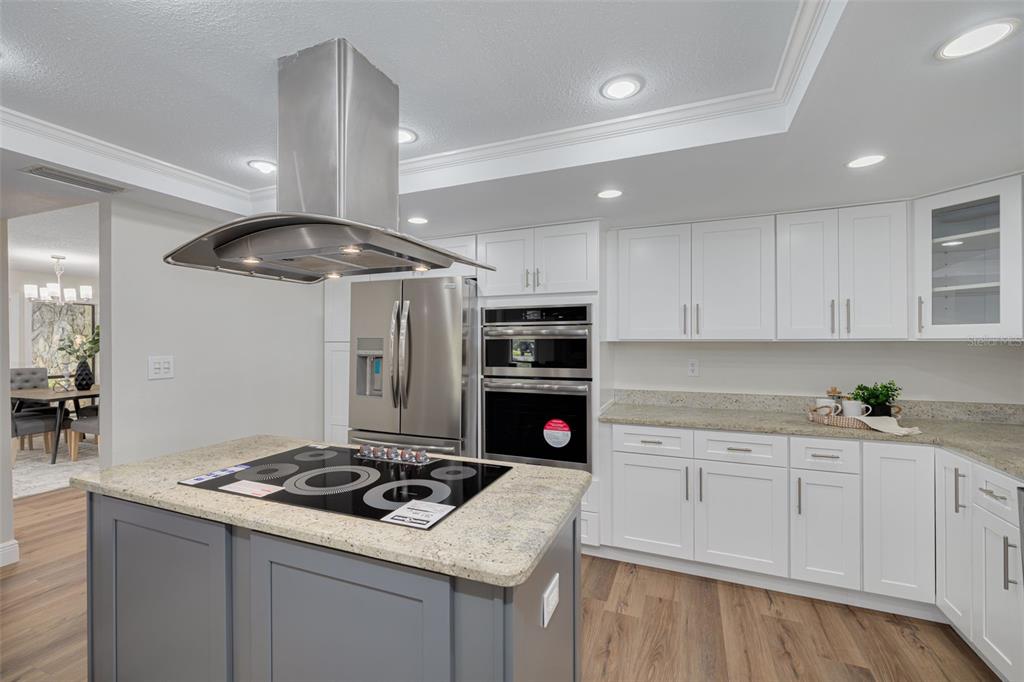 4415 Marine Parkway New Port Richey, FL 34652 - Photo 13 of 61 a kitchen with a sink stainless steel appliances and white cabinets