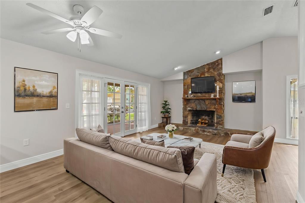 4415 Marine Parkway New Port Richey, FL 34652 - Photo 16 of 72 a living room with furniture a fireplace and a flat screen tv