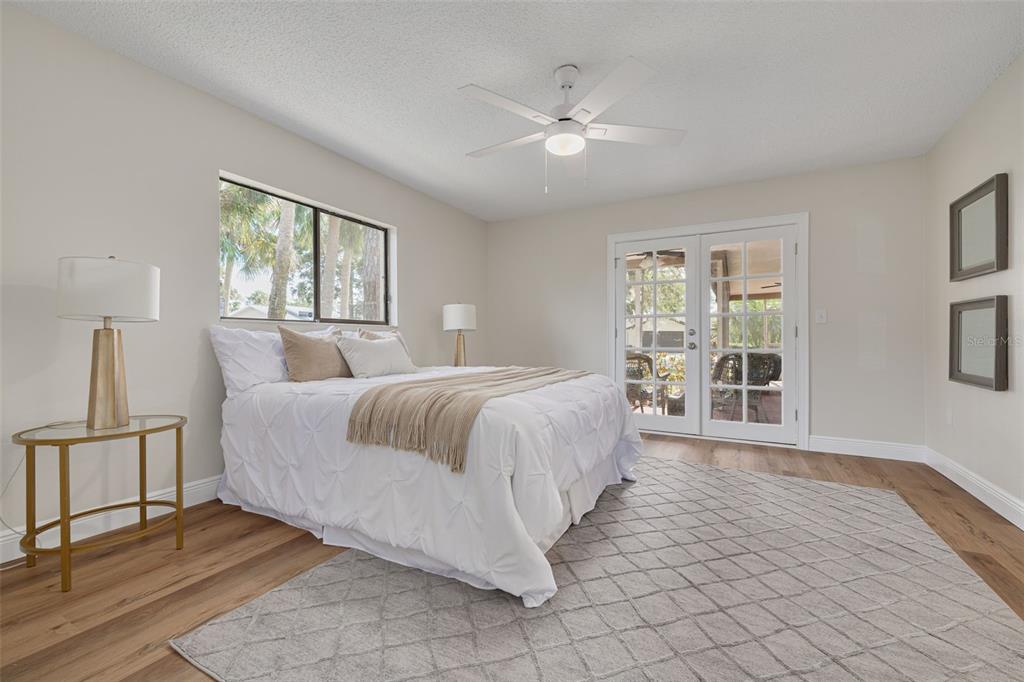 4415 Marine Parkway New Port Richey, FL 34652 - Photo 20 of 61 a spacious bedroom with a large bed and a window