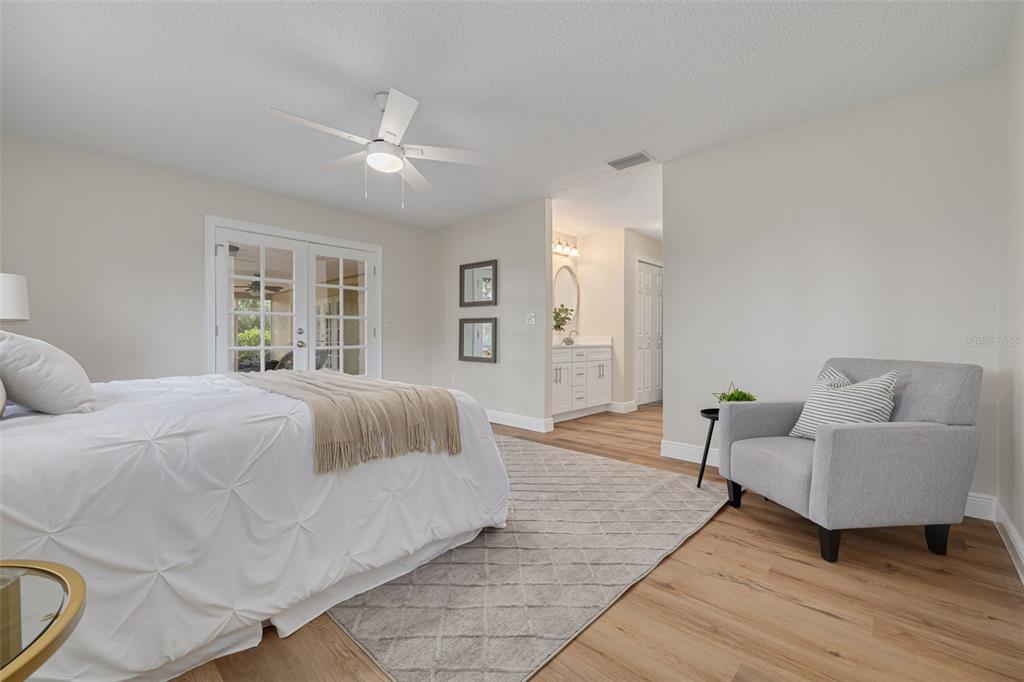 4415 Marine Parkway New Port Richey, FL 34652 - Photo 21 of 61 a spacious bedroom with a bed and a couch