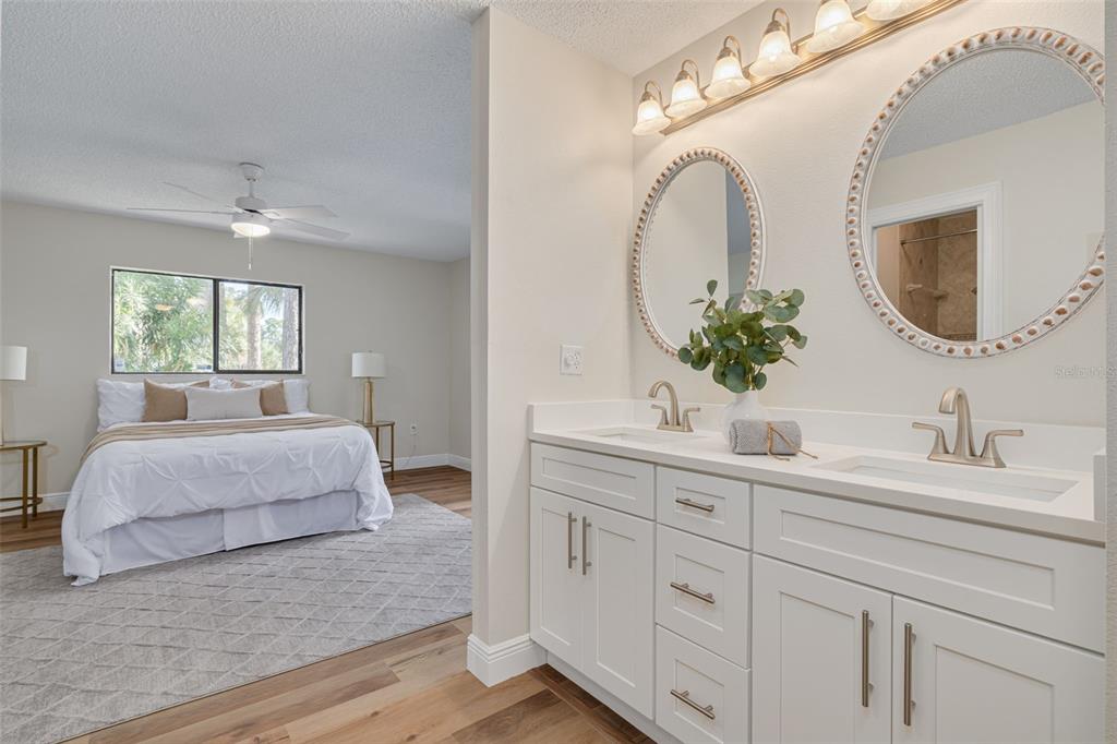 4415 Marine Parkway New Port Richey, FL 34652 - Photo 23 of 61 a en suite bathroom with a double vanity sink and a mirror