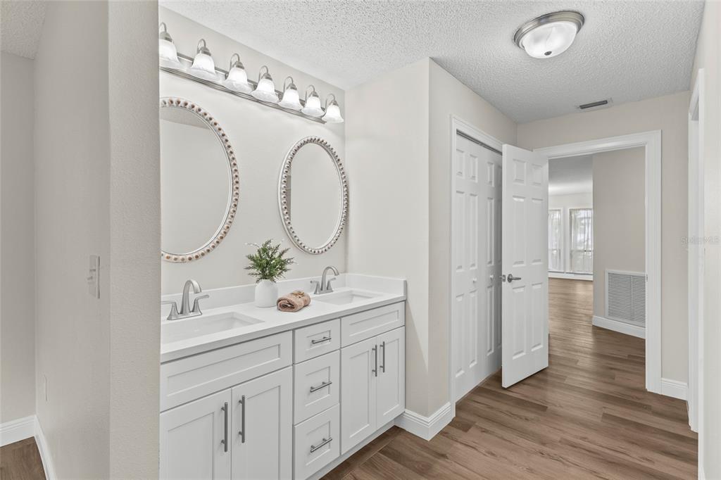 4415 Marine Parkway New Port Richey, FL 34652 - Photo 26 of 72 a en suite bathroom with a double vanity sink and a mirror