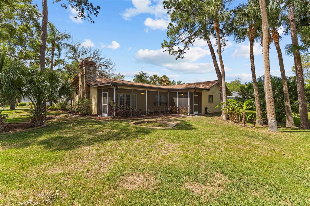 4415 Marine Parkway New Port Richey, FL 34652 - Photo 5 of 72 a swimming pool with outdoor seating and yard