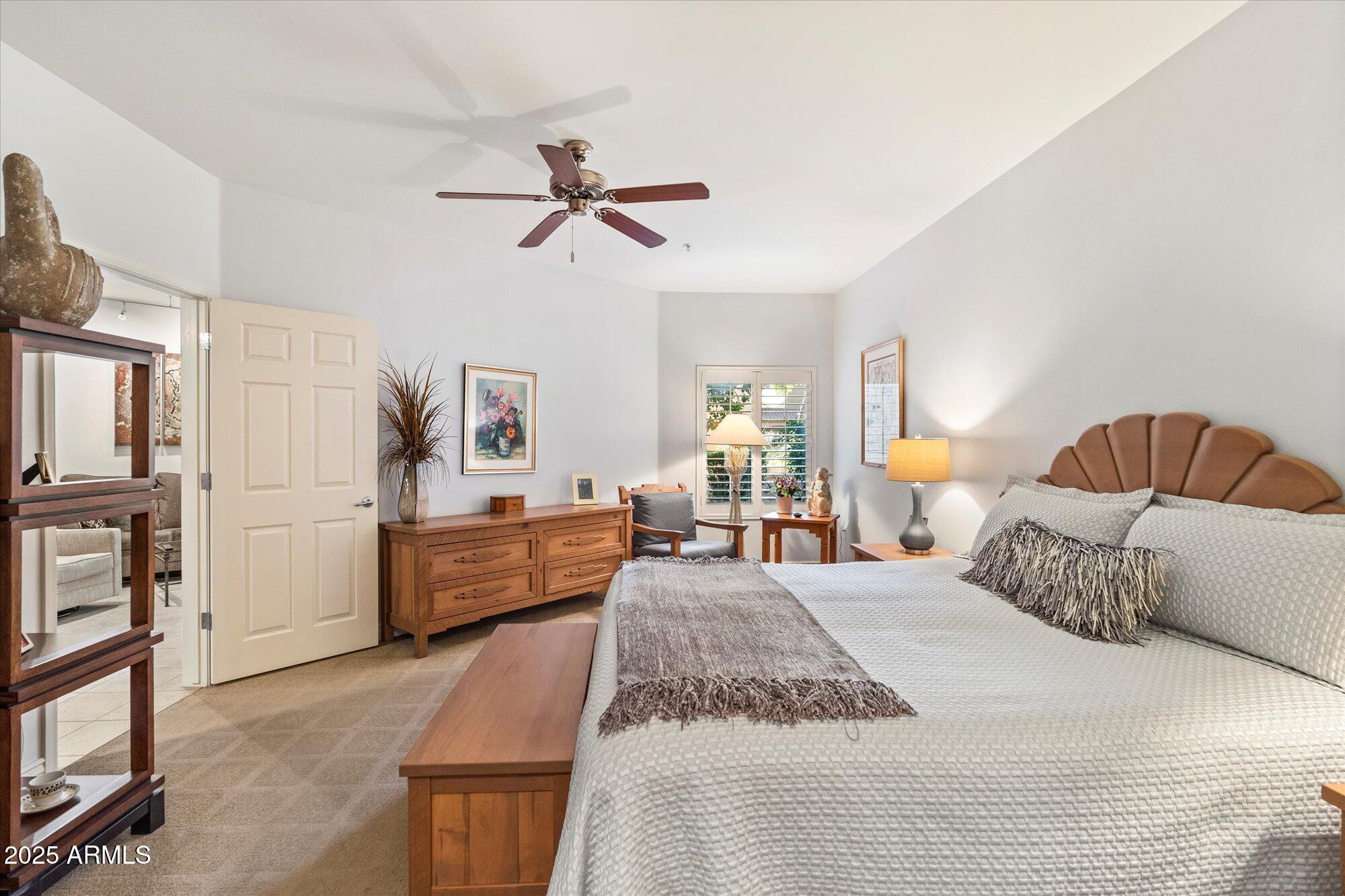 5350 East Deer Valley Drive, Unit 1238 Phoenix, AZ 85054 - Photo 12 of 29 a bedroom with a large bed and a couch