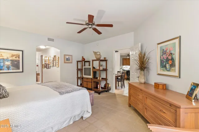 a bedroom with a large bed and a couch