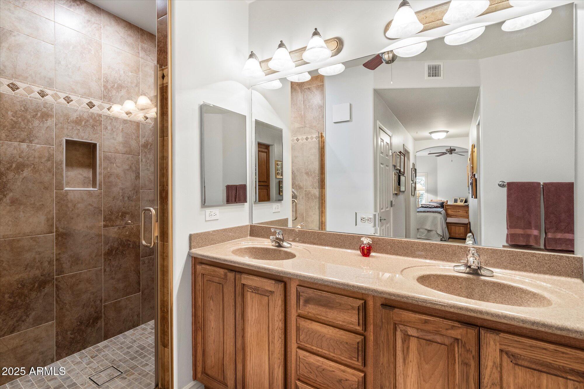 5350 East Deer Valley Drive, Unit 1238 Phoenix, AZ 85054 - Photo 14 of 29 a bathroom with a double vanity sink mirror and shower